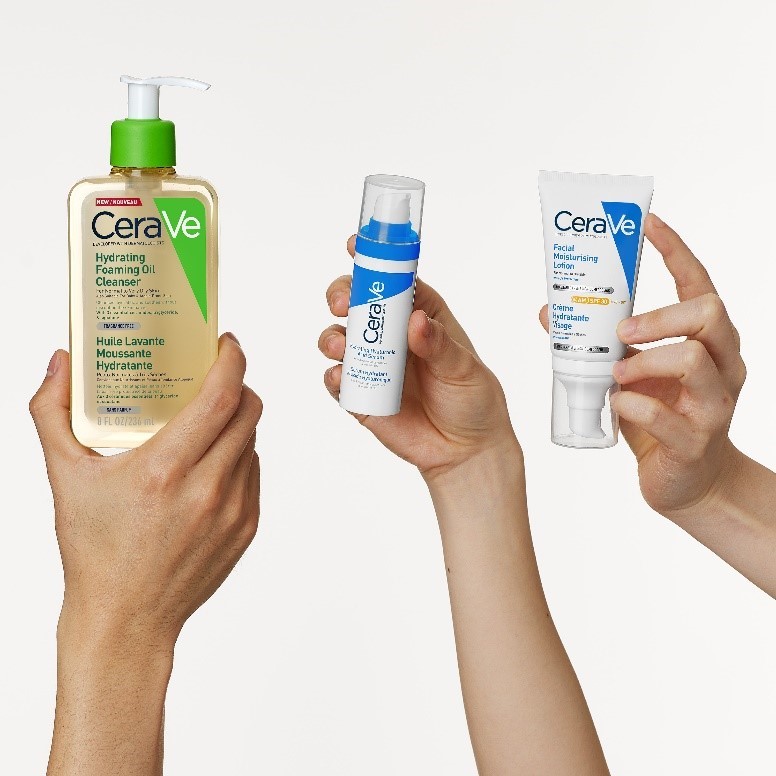 3 hands each holding a hydrating CeraVe product. From left to right: Hydrating Foaming Oil Cleanser, Hydrating Hyaluronic Acid Serum, and Facial Moisturising Lotion SPF50